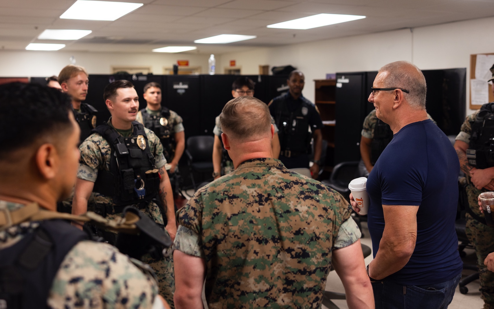 Celebrity chef and talk show host Robert Irvine speaks to Marines with Marine Corps Base Quantico’s Provost Marshal’s Office while visiting MCB Quantico, Virginia, July 11, 2025. Chef Irvine visited the base to show his support for military and civilian people who make up the Crossroads of the Marine Corps.