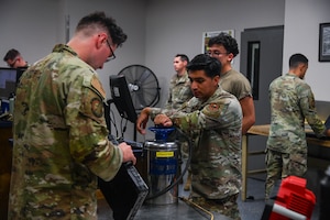 Service members check out tools.