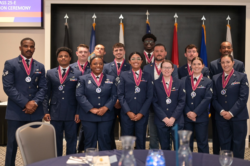 Airman Leadership School Class 25-E takes a class photo at the beginning of the ALS Class 25-E graduation at the Powell Event Center, Goodfellow Air Force Base, Texas, July 10, 2025. ALS is a five-week course designed to prepare senior airmen to assume supervisory duties through instruction in leadership, followership and written and oral communication skills. (U.S. Air Force photo by Senior Airman Evelyn J. D’Errico)