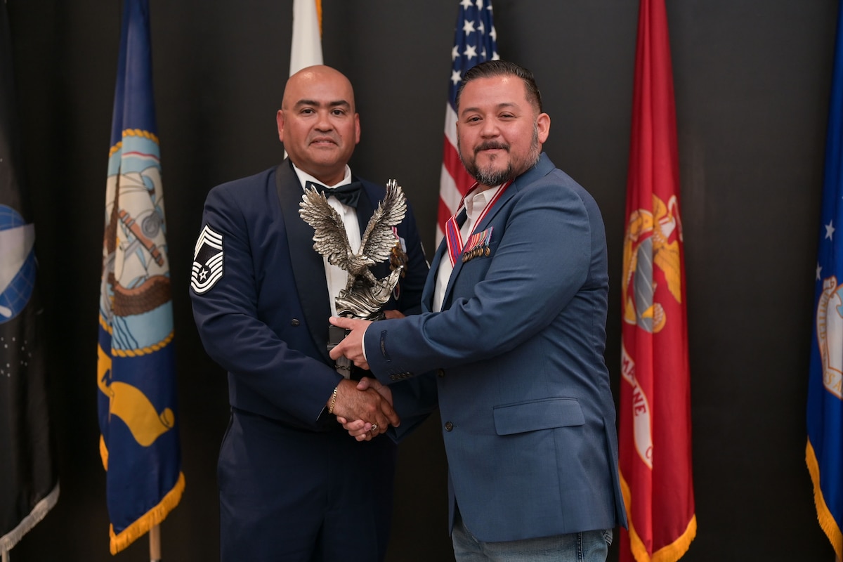 U.S. Air Force Chief Master Sgt. Jason Ramon, 17th Mission Support Group senior enlisted leader, presents Mr. Armando Garcia, 47th Maintenance Directorate aircraft mechanic, with the Distinguished Graduate award during the ALS Class 25-E graduation at the Powell Event Center, Goodfellow Air Force Base, Texas, July 10, 2025. The Distinguished Graduate Award is based upon demonstrated leadership and academic performance; the Distinguished Graduate is in the top 10 percent of Class 25-E. (U.S. Air Force photo by Senior Airman Evelyn J. D’Errico)