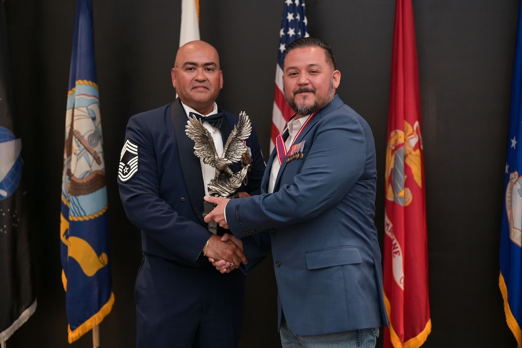 U.S. Air Force Chief Master Sgt. Jason Ramon, 17th Mission Support Group senior enlisted leader, presents Mr. Armando Garcia, 47th Maintenance Directorate aircraft mechanic, with the Distinguished Graduate award during the ALS Class 25-E graduation at the Powell Event Center, Goodfellow Air Force Base, Texas, July 10, 2025. The Distinguished Graduate Award is based upon demonstrated leadership and academic performance; the Distinguished Graduate is in the top 10 percent of Class 25-E. (U.S. Air Force photo by Senior Airman Evelyn J. D’Errico)