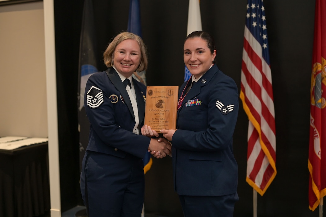 U.S. Senior Airman Ashley McPeek, 17th Operational Medical Readiness Squadron public health technician, receives the Airman Leadership Commandant award from Master Sgt. Kristin Hingstrum, Goodfellow Airman Leadership School commandant, during the Airman Leadership School Class 25-E Graduation Ceremony at the Powell Event Center, Goodfellow Air Force Base, Texas, July 10, 2025. ALS equips Airmen with the skills to lead and manage in dynamic, complex and uncertain environments. (U.S. Air Force photo by Senior Airman Evelyn J. D’Errico)