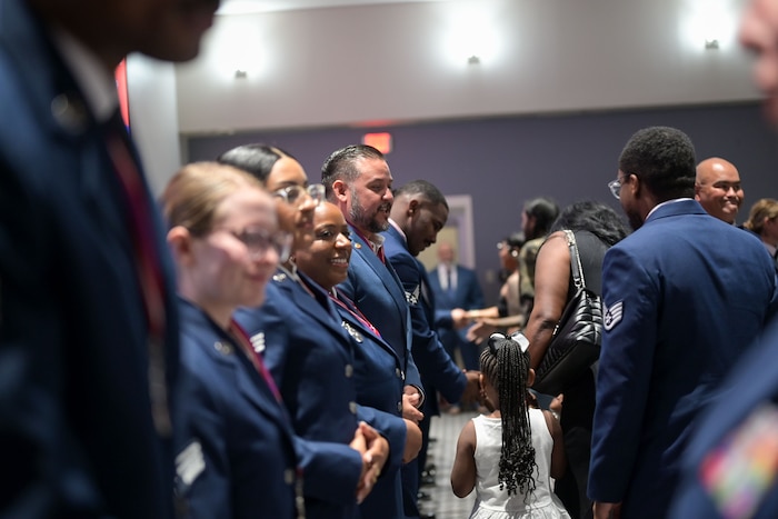 Airman Leadership School Class 25-E stands in the front of the room as friends and family congratulate them during the closing of the ALS Class 25-E graduation at the Powell Event Center, Goodfellow Air Force Base, Texas, July 10, 2025. ALS prepares Airmen to be adaptable for current and future leadership and management challenges to operate in complex and ambiguous environments. (U.S. Air Force photo by Senior Airman Evelyn J. D’Errico)