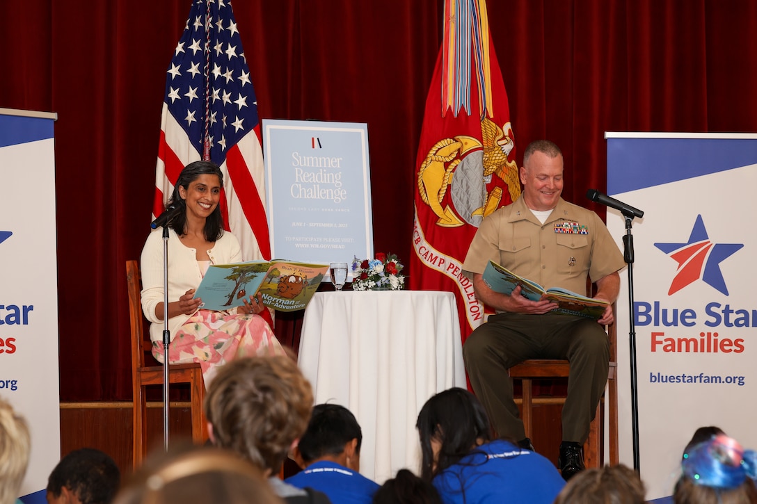 The Second Lady of the United States, Usha Vance, left, and U.S. Marine Corps Col. Charles E. Dudik, the chief of staff of Marine Corps Installations West, read a book to young boys and girls during the Blue Star Family Reading Event with Disney at the Pacific Views Event Center at Marine Corps Base Camp Pendleton, California, July 11, 2025. Blue Star Families and Disney partnered with Marine Corps Community Services to host a book fair featuring Vance as a special guest reader, celebrating her Summer Reading Challenge. The initiative aimed to promote literacy and foster a love of reading amongst children and families within the community. (U.S. Marine Corps photo by Cpl. Madisyn Paschal)