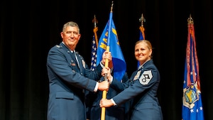 Col Stremmel and Chief Sanders holding guidon