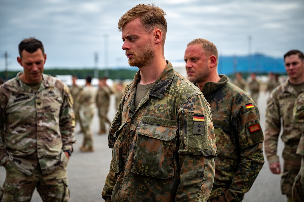 German Army liaison 1st Lt. Tim H. receives equipment during a personnel deployment function line in support of Talisman Sabre at Joint Base Elmendorf-Richardson, Alaska, July 13, 2025.