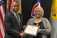 Ronald Houston, U.S. Army Financial Management Command Military Pay Operations Readiness East branch chief and senior financial manager, presents Wilhemenia Taylor, USAFMCOM MPO financial management analyst, with a certificate of retirement during Taylor’s retirement ceremony at the Maj. Gen. Emmett J. Bean Federal Center in Indianapolis June 30, 2025. Taylor retired from USAFMCOM after more than 30 years of federal civil service and 15 years of military service. (U.S. Army photo by Mark R. W. Orders-Woempner)