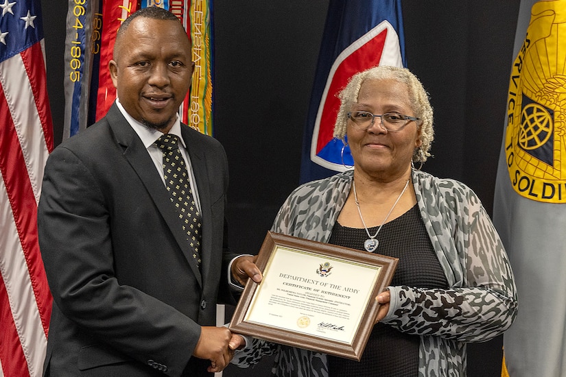 Ronald Houston, U.S. Army Financial Management Command Military Pay Operations Readiness East branch chief and senior financial manager, presents Wilhemenia Taylor, USAFMCOM MPO financial management analyst, with a certificate of retirement during Taylor’s retirement ceremony at the Maj. Gen. Emmett J. Bean Federal Center in Indianapolis June 30, 2025. Taylor retired from USAFMCOM after more than 30 years of federal civil service and 15 years of military service. (U.S. Army photo by Mark R. W. Orders-Woempner)