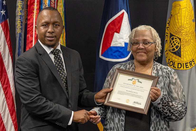 Ronald Houston, U.S. Army Financial Management Command Military Pay Operations Readiness East branch chief and senior financial manager, presents Wilhemenia Taylor, USAFMCOM MPO financial management analyst, with a Department of the Army Civilian Service Commendation Medal during Taylor’s retirement ceremony at the Maj. Gen. Emmett J. Bean Federal Center in Indianapolis June 30, 2025. Taylor retired from USAFMCOM after more than 30 years of federal civil service and 15 years of military service. (U.S. Army photo by Mark R. W. Orders-Woempner)