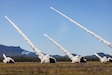 High Mobility Artillery Rocket Systems from the Australian Army, the United States Army and the Singapore Army fire a salvo of rockets during a combined joint live fire exercise in Queensland, Australia during Exercise Talisman Sabre 25.