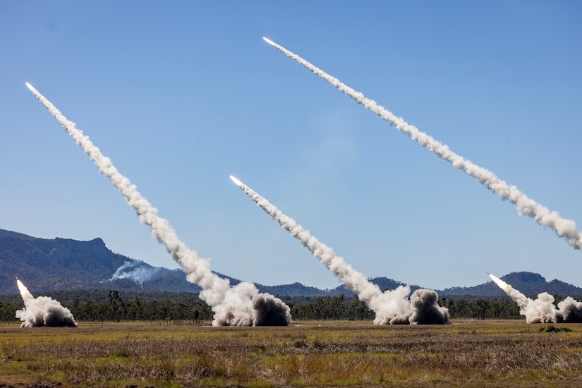 High Mobility Artillery Rocket Systems from the Australian Army, the United States Army and the Singapore Army fire a salvo of rockets during a combined joint live fire exercise in Queensland, Australia during Exercise Talisman Sabre 25.