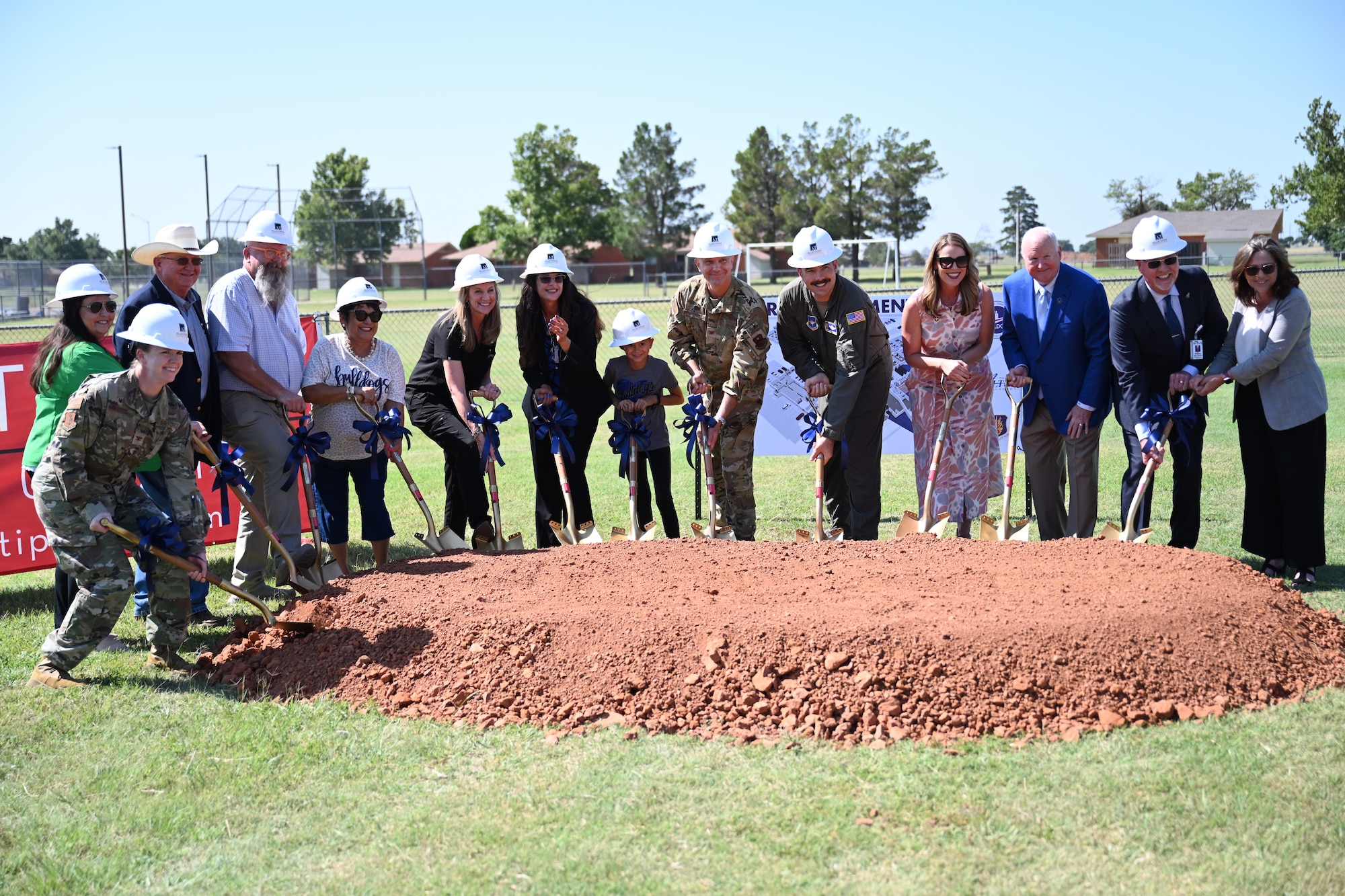 Leadership from the 97th Air Mobility Wing and distinguished guests perform the ‘first dig’ at the site of the new schoolhouse at Altus Air Force Base, Oklahoma, July 8, 2025. The new schoolhouse is valued at $62 million and will be replacing the current facility. (U.S. Air Force photo by Airman 1st Class Nathan Langston)