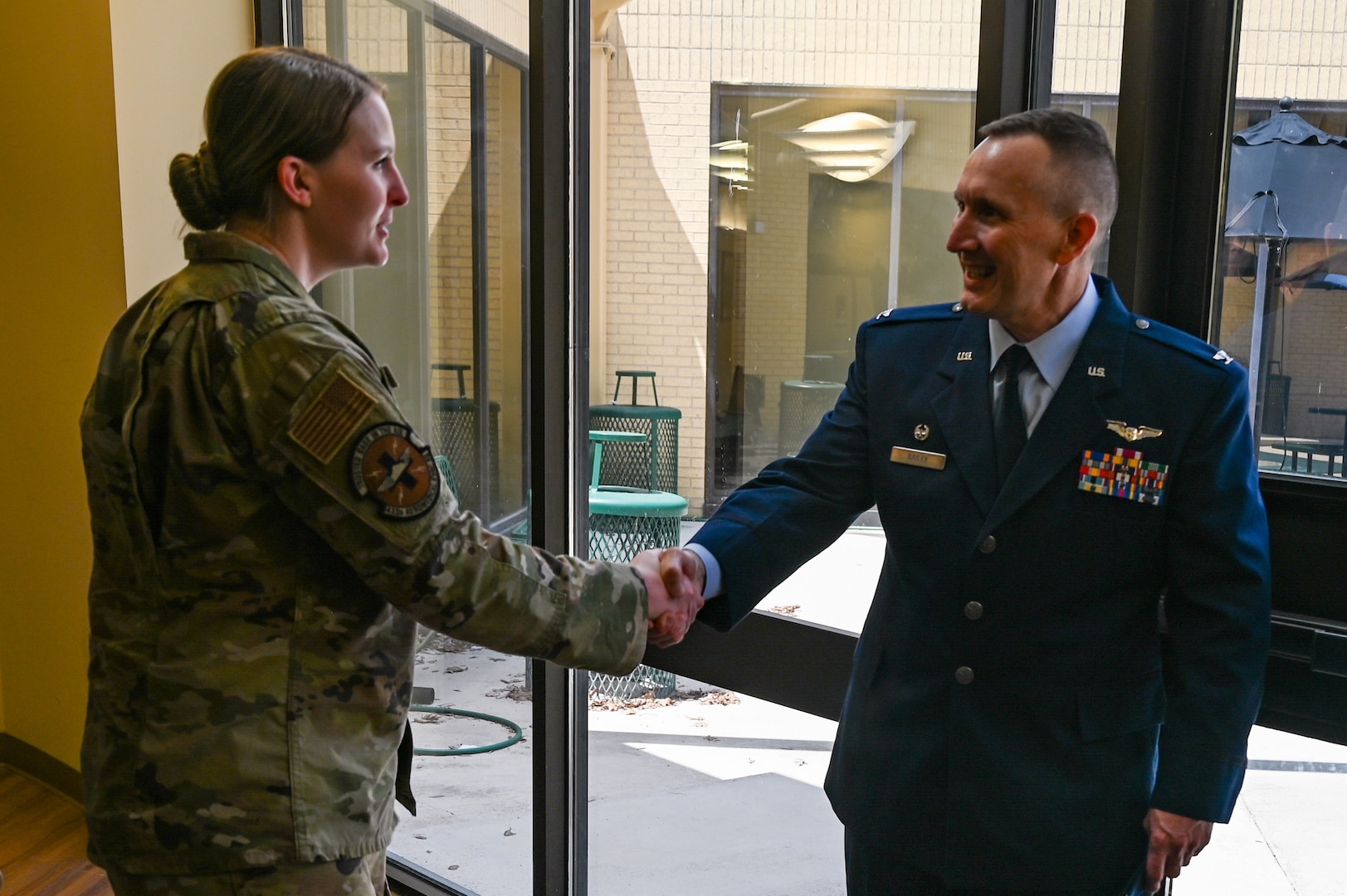 Col. David Bailey, 433rd Aeromedical Evacuation Squadron commander, shakes hands with one of the Citizen Airmen now under his command following an assumption of command ceremony at Joint Base San Antonio-Lackland, Texas, July 12, 2025.