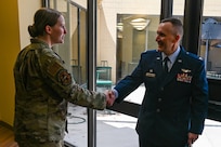 Col. David Bailey, 433rd Aeromedical Evacuation Squadron commander, shakes hands with one of the Citizen Airmen now under his command following an assumption of command ceremony at Joint Base San Antonio-Lackland, Texas, July 12, 2025.