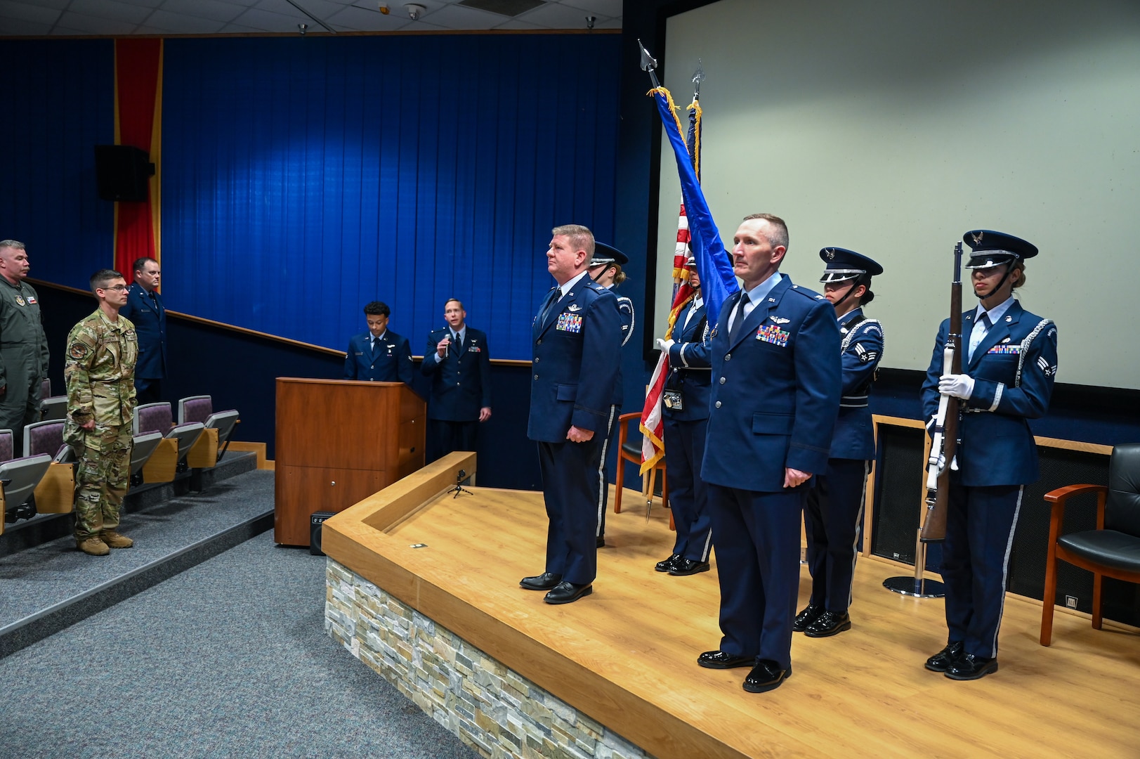Members of the official party stand at attention while the honor guard renders honors during the playing of the national anthem as part of an assumption of command ceremony for the 433rd Aeromedical Evacuation Squadron at Joint Base San Antonio-Lackland, Texas, July 12, 2025.