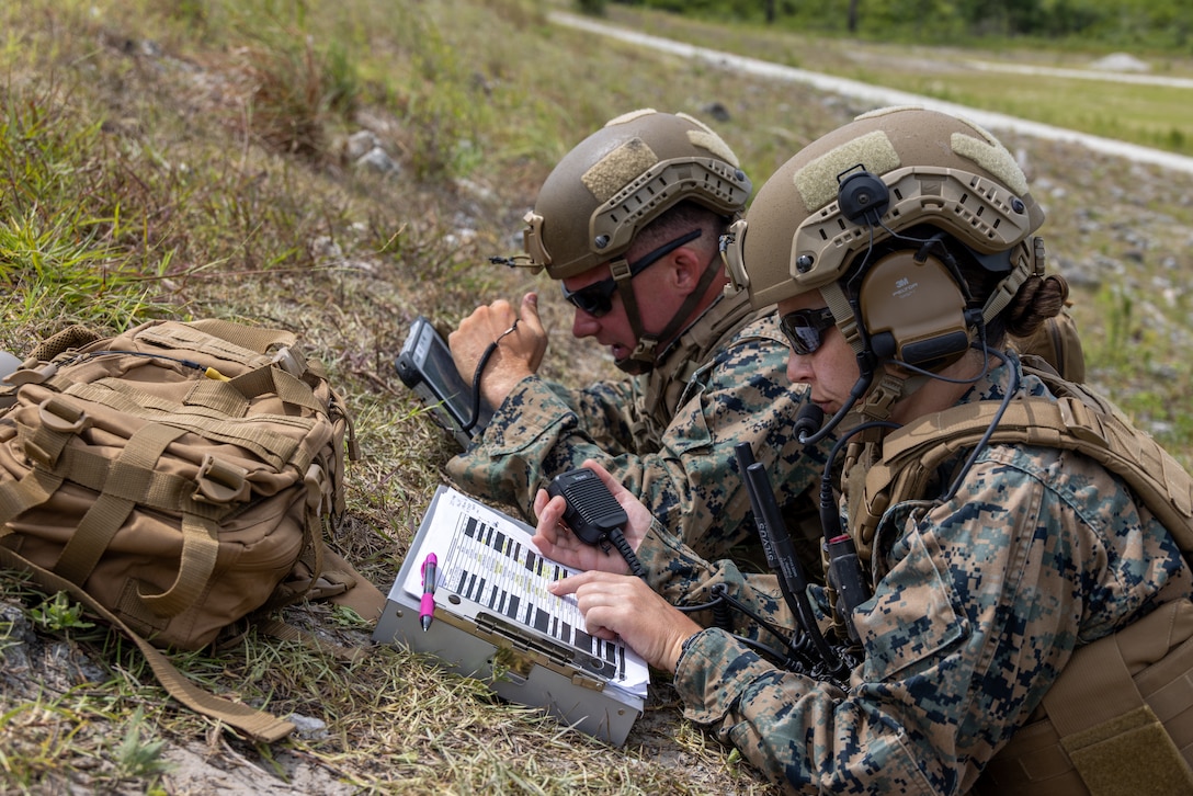 U.S. Marine Corps Staff Sgt. Ronald Johnson II, back, an instructor with Small Unmanned Aircraft Systems School, Advanced Infantry Training Battalion, and a native of South Carolina, and Maj. Jessica Del Castillo, front, the officer in charge of SUASS, AITB, and a native of South Carolina, operate an R80D SkyRaider small unmanned aircraft system (SUAS) in preparation for a combined arms live-fire training exercise involving the employment of SUAS to deliver munitions on designated targets at Camp Lejeune, North Carolina, July 2, 2025. This event marked the first time munitions were employed from SUAS during a live-fire training exercise on Camp Lejeune, demonstrating the capability of integrating aerial strike capabilities at the tactical level. (U.S. Marine Corps photo by Cpl. Zachariah Ferraro)