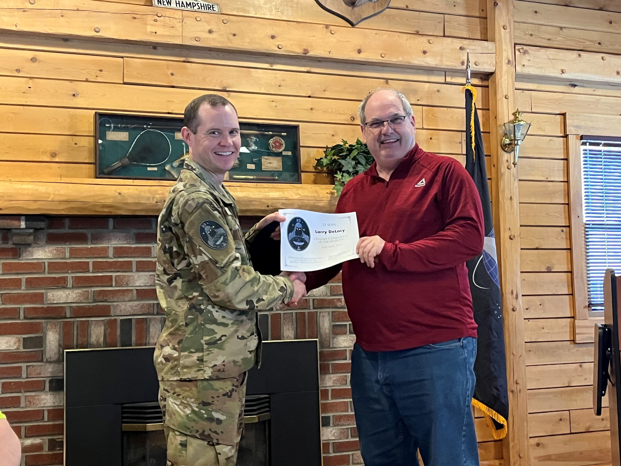 A man accepts an award from his commander