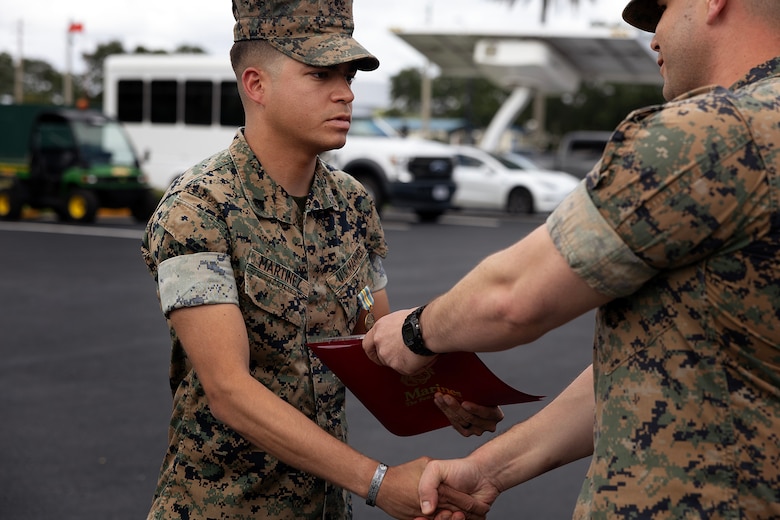 U.S. Marine Corps Cpl. Nicholas Martinez receives a Military Outstanding Volunteer Service Medal