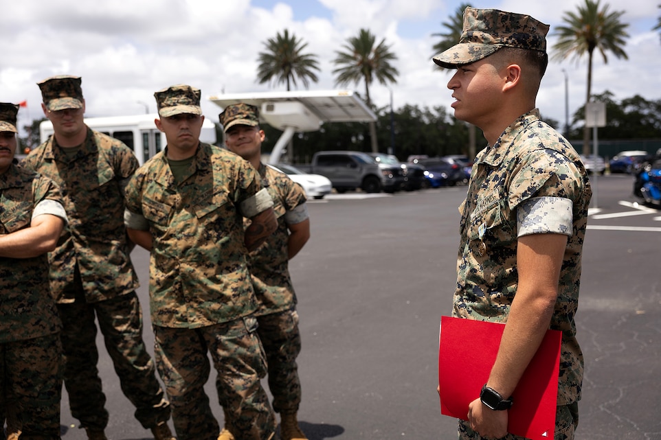 U.S. Marines listen to Cpl. Nicholas Martinez