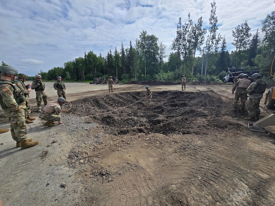 A Fiber Reinforced Polymer matting team from the 354th Civil Engineering Squadron takes crater diameter measurements at Joint Base Elmendorf-Richardson, Alaska, June 18, 2025.