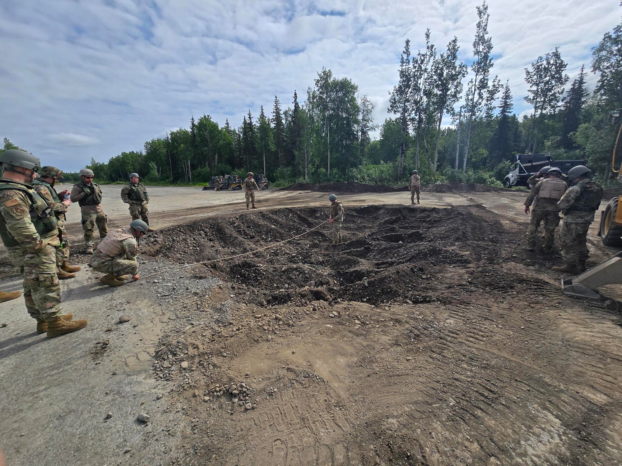 A Fiber Reinforced Polymer matting team from the 354th Civil Engineering Squadron takes crater diameter measurements at Joint Base Elmendorf-Richardson, Alaska, June 18, 2025.