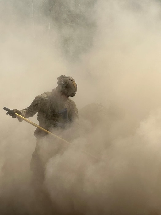 U.S. Air Force Senior Airman Brenden Sherwin, 354th Civil Engineering Squadron Airman, clears a crater of debris at Joint Base Elmendorf-Richardson, Alaska, June 19, 2025.