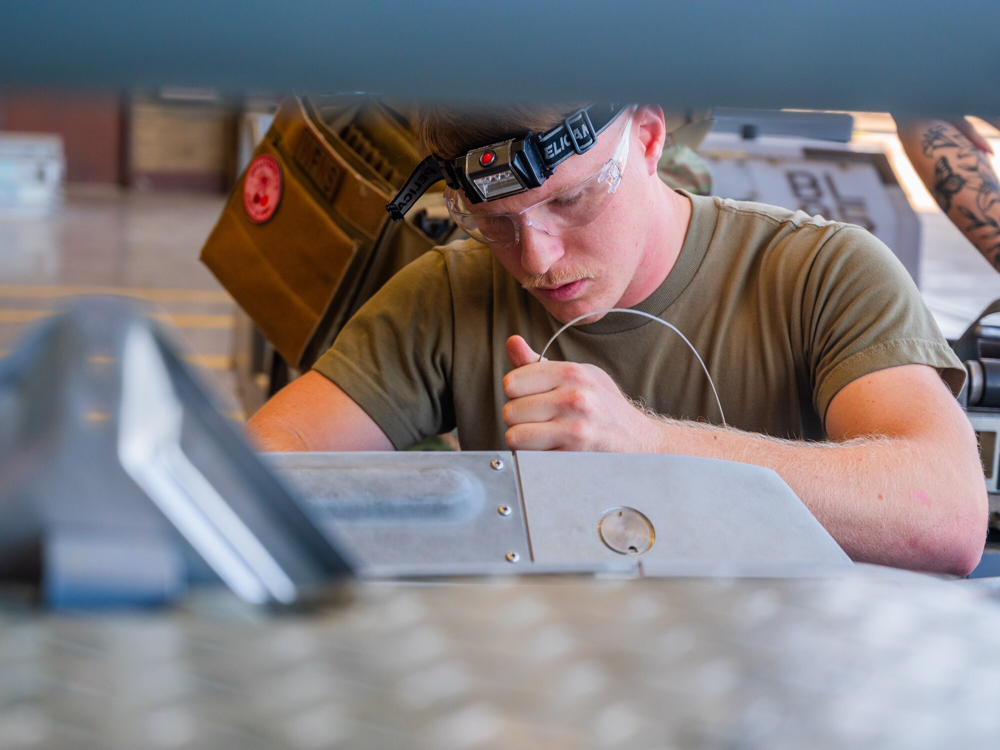 U.S. Air Force Senior Airman Austin Murray (front), 62nd Aircraft Maintenance Unit weapons load team member, examines training ordnance during the 56th Fighter Wing’s third quarterly load competition, July 11, 2025, at Luke Air Force Base, Arizona.