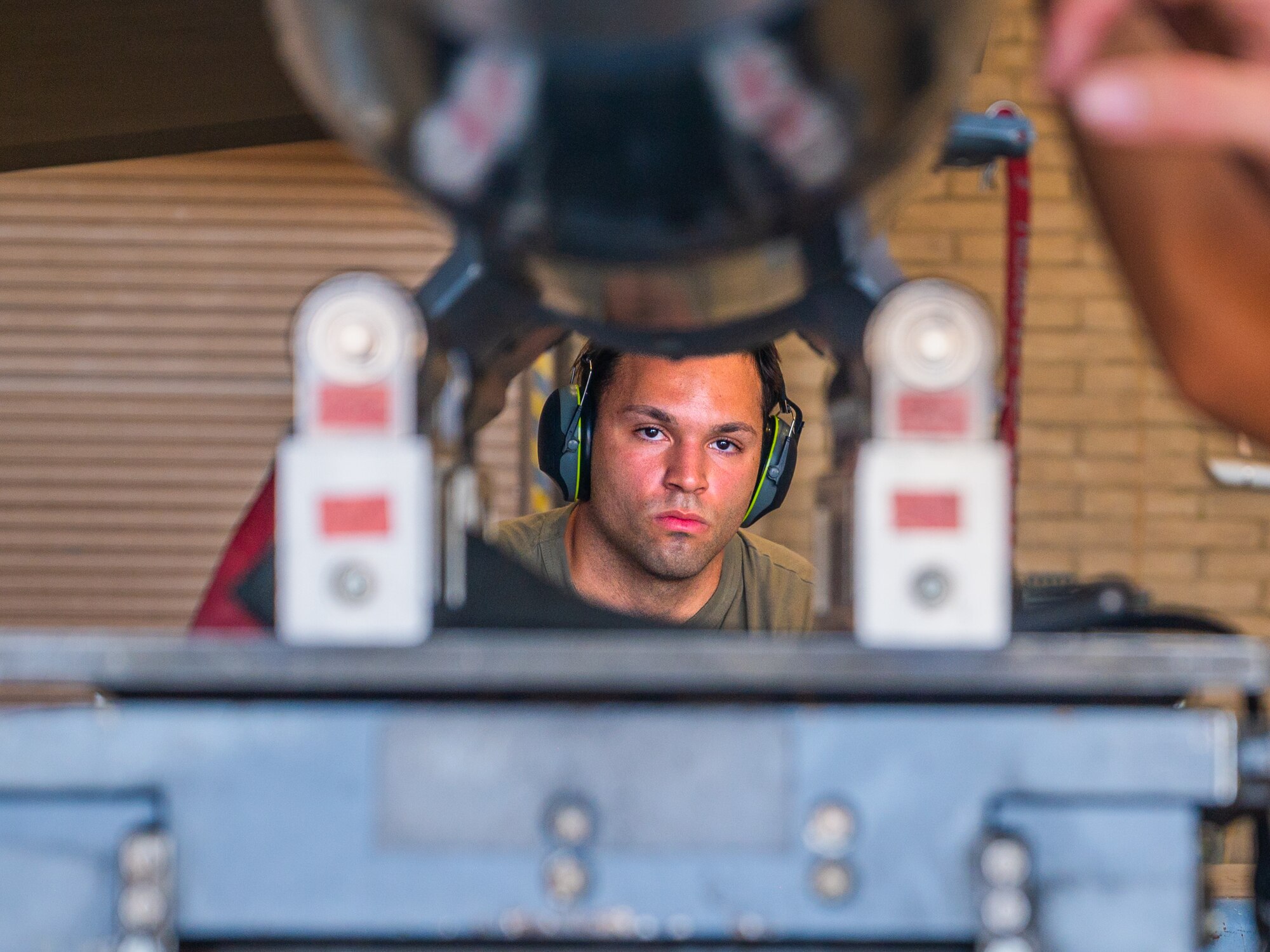 U.S. Air Force Force Senior Airman Mark Anthony Colon, 62rd Aircraft Maintenance Unit weapons load team member, uses a MJU-1 Lift Truck to load training ordnance onto an F-35A Lighnting II during the 56th Fighter Wing’s third quarterly load competition, July 11, 2025, at Luke Air Force Base, Arizona.