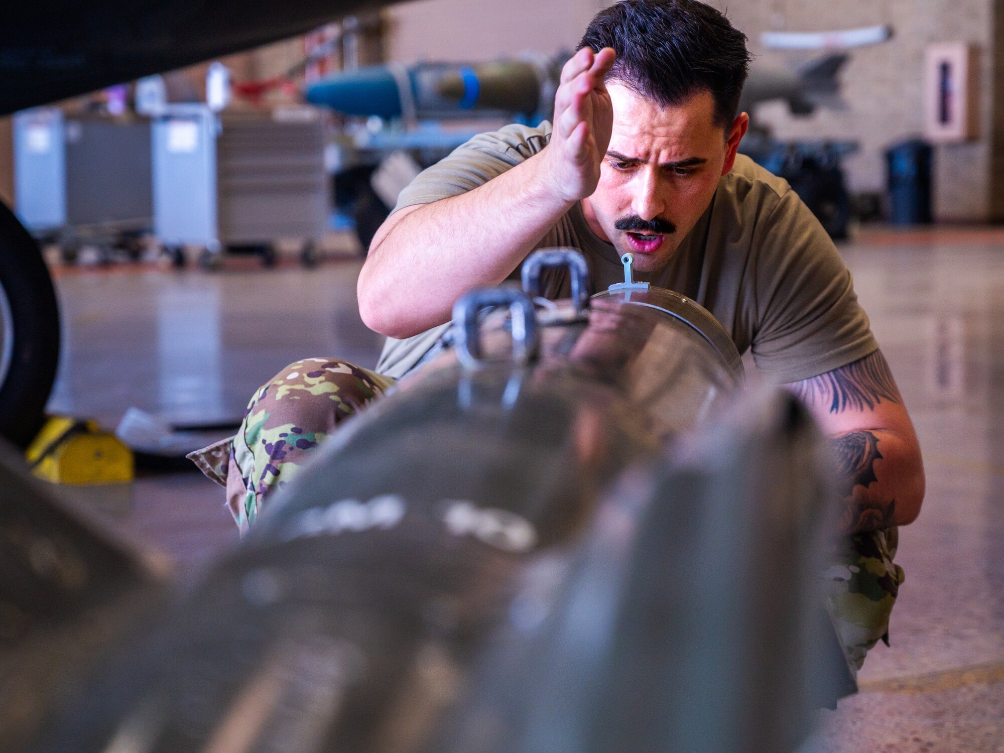 U.S. Air Force Staff Sgt Taylor Christensen, 62nd Aircraft Maintenance Unit weapons load team member, examines training ordnance during the 56th Fighter Wing’s third quarterly load competition, July 11, 2025, at Luke Air Force Base, Arizona.