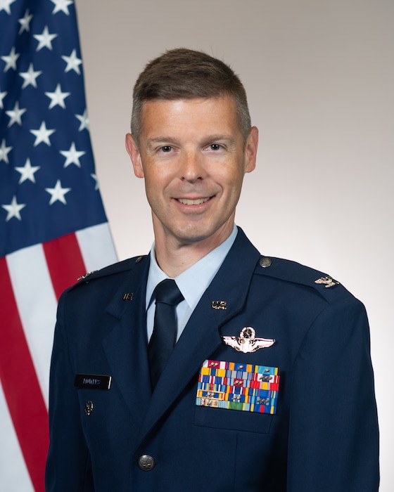 Col Mowers stands in front of the US Flag his official portrait.
