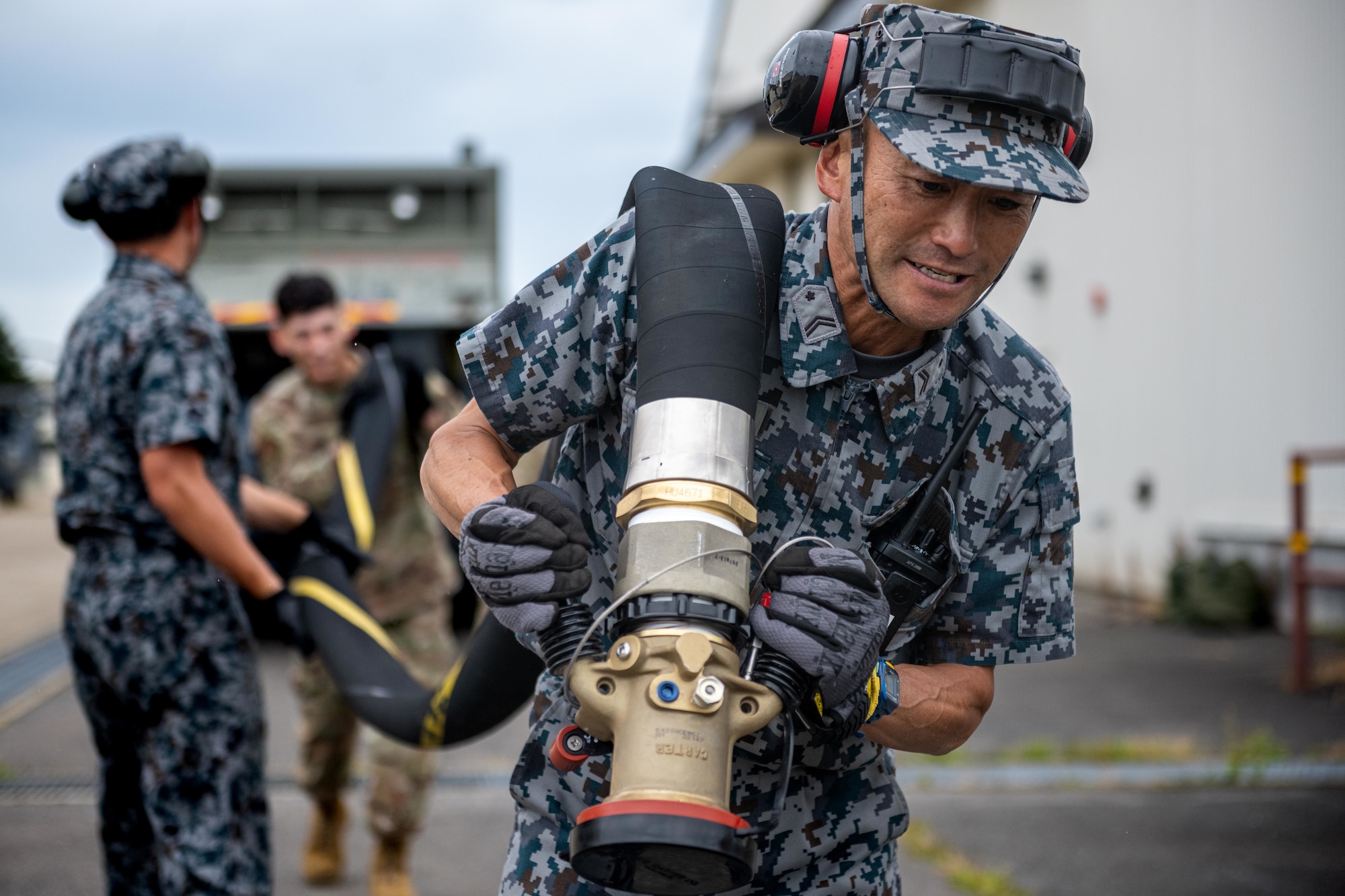 Japan Air Self-Defense Force (JASDF) Staff Sgt. Utaka Musha, 3rd Air Wing petroleum, oil, and lubricant technician, pulls a fuel line from a JASDF refueling truck during exercise Resolute Force Pacific (REFORPAC) 2025.