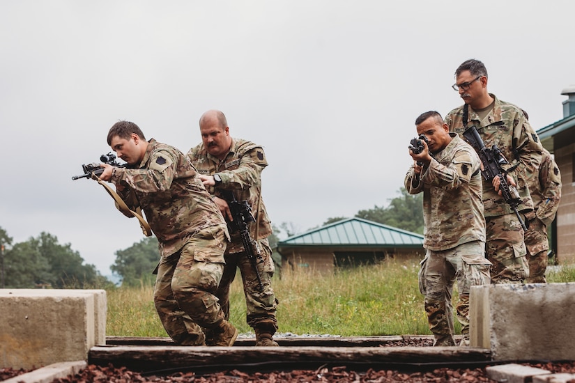Soldiers with Bravo Company, 1st Battalion, 112th Infantry Regiment, 56th Stryker Brigade Combat Team practice various close quarter battle techniques at the live fire shoot house complex at Fort Indiantown Gap, Pennsylvania, June 10, 2025. The Soldiers conducted several iterations to practice movement while firing live rounds. (U.S. Army National Guard photo by Staff Sgt. Jonathan Campbell)