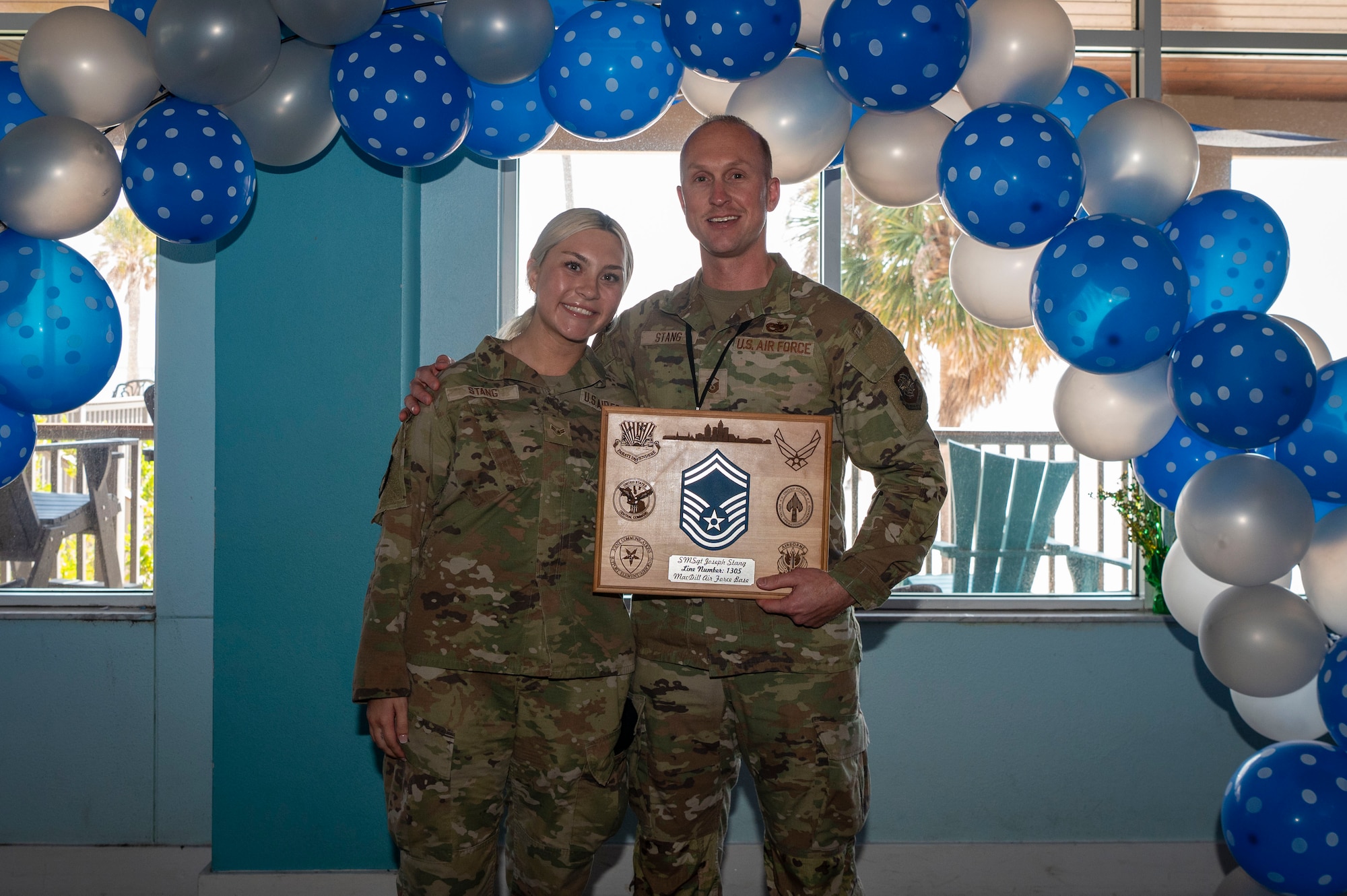 U.S. Air Force MSgt. Joseph Stang, 6th Aircraft Maintenance Squadron production superintendent, and daughter, Airman 1st Class Isabella Stang, a 6th Security Forces Squadron administration and reports clerk, pose for a photo during a Senior Master Sergeant release celebration at MacDill Air Force Base, Florida, March 13, 2025. This father and daughter duo have had the rare opportunity to be stationed at the same base at the same time, serving in the 6th Air Refueling Wing’s mission to project air-refueling power worldwide. (U.S. Air Force photo by Senior Airman Alicia Campbell)