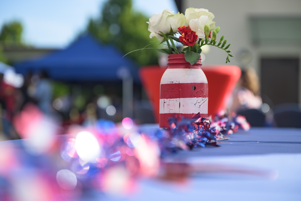 A vase of flowers sits on a decorated table.