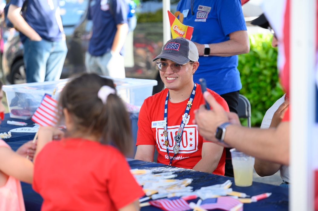 A man sits at a USO booth.