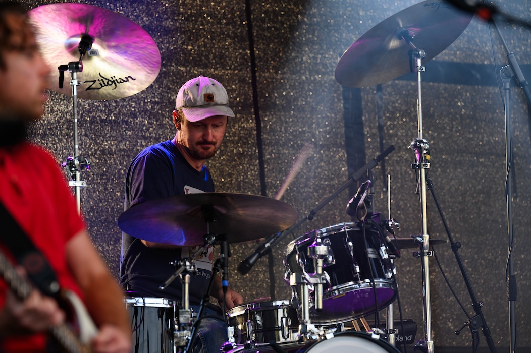A man plays drums.