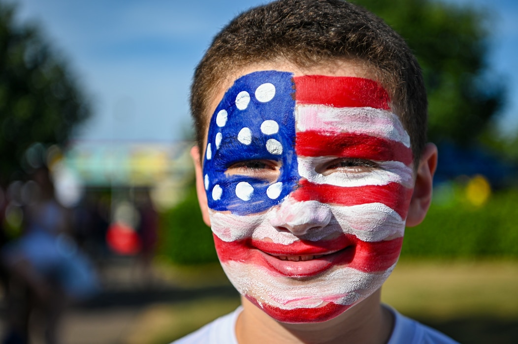 Child with American flag face paint.
