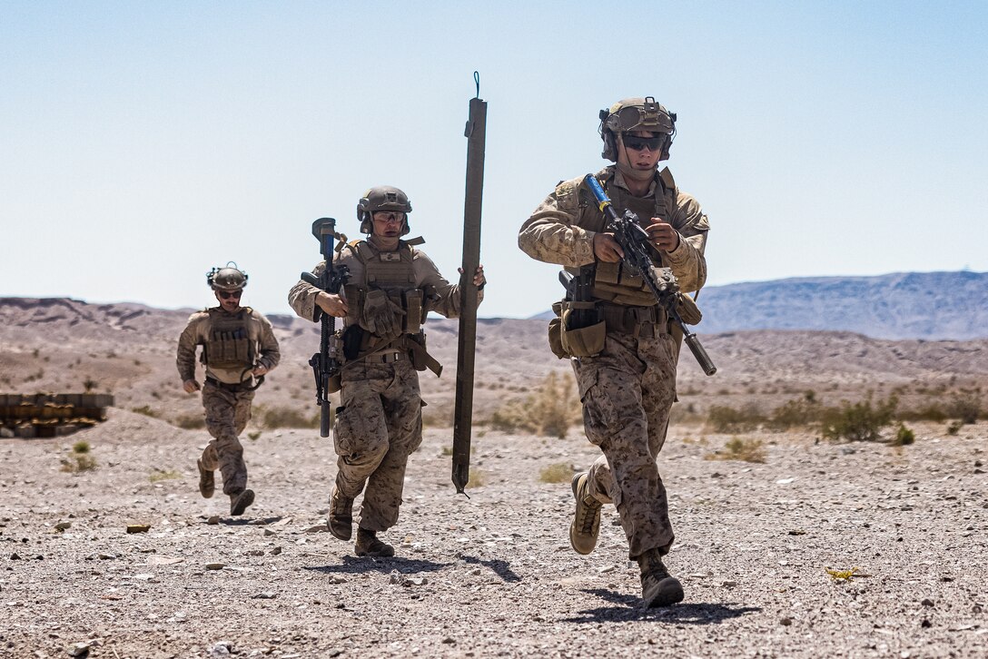 U.S. Marines with 2d Combat Engineer Battalion, 2d Marine Division, maneuvers to their next position during Service Level Training Exercise 4-25, on Range 114 at Marine Corps Air-Ground Combat Center, Twentynine Palms, California, July 13, 2025. SLTE 4-25 is designed to be a challenging, realistic training environment that produces combat-ready forces capable of operating as an integrated Marine Air Ground Task Force across all domains of military operations. (U.S. Marine Corps photo by Lance Cpl. Judith Ann Lazaro)