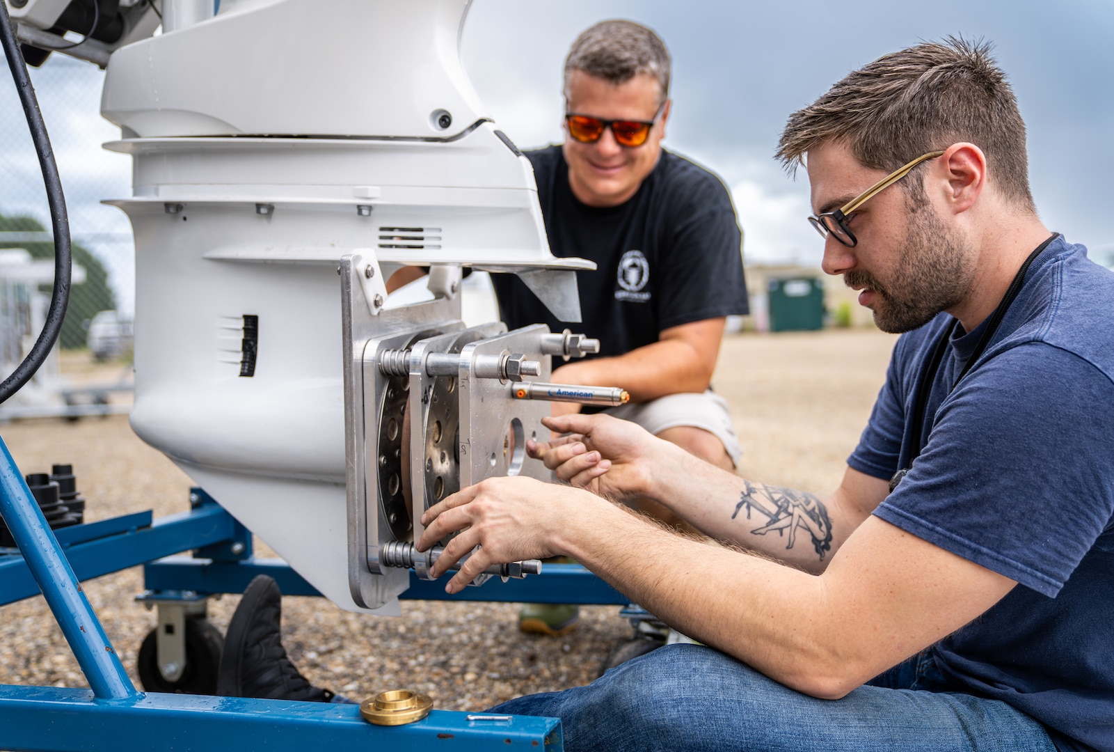DAHLGREN, Va. – Adam Suleske (left) and August Valentour, subject matter experts from Naval Surface Warfare Center Dahlgren Division (NSWCDD), assemble an Outboard Motor Dynamometer. This device, developed by participants in the 2024-2025 Virginia Tech Interdisciplinary Capstone Program, enhances NSWCDD’s testing capabilities for High Power Microwave Weapon Systems. The innovative design features remote control capabilities, a universal adapter for easy motor connections, and a failsafe coupling system for optimal safety and efficiency. (Dorina Watermolen/NSWCDD Photo)