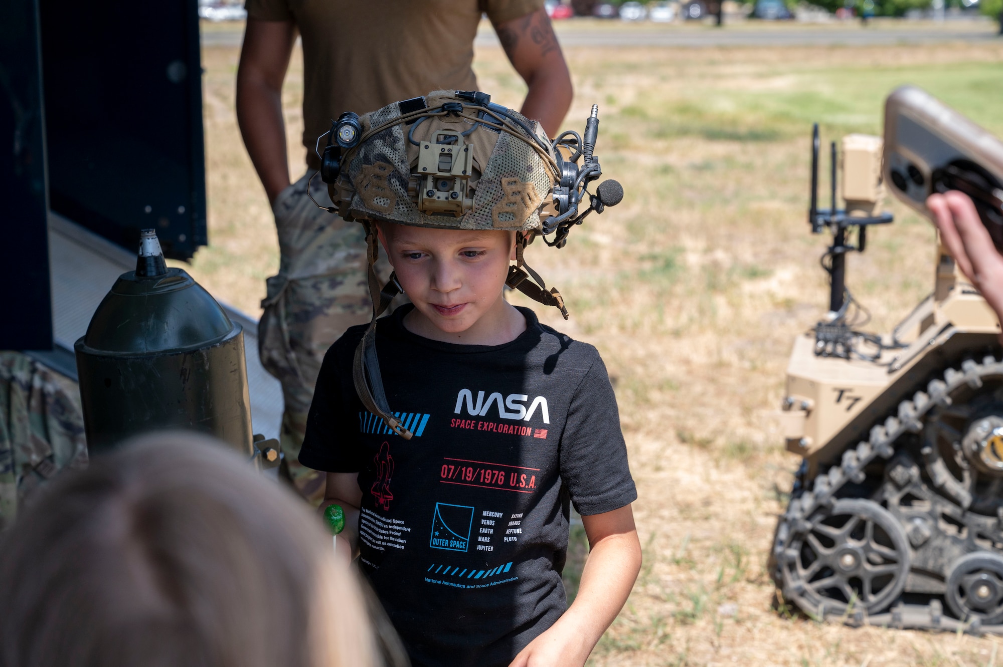 A young attendee at the KUDOS events wears a helmet.