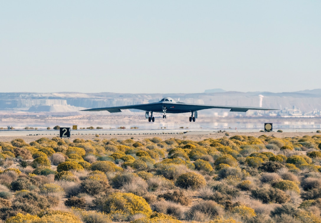 B-21 Raider hovers above desert ground while conducting flight testing.