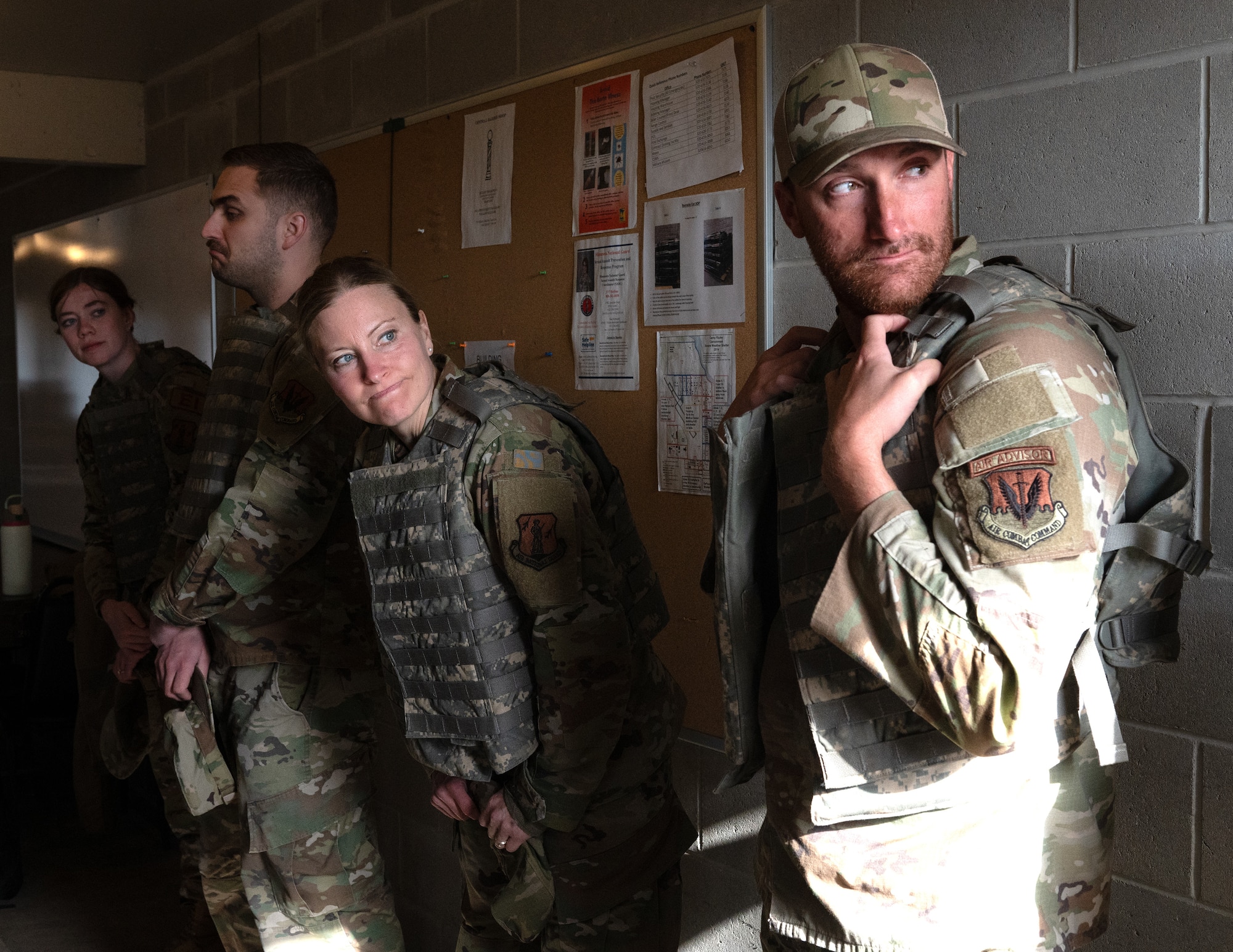 U.S. Air Force Airmen from the 205th Engineering Installation Squadron, Oklahoma Air National Guard, and the 210th Engineering Installation Squadron, Minnesota Air National Guard, listen to instructions for weapon safety in Camp Ripley, Minn., May 1, 2025.