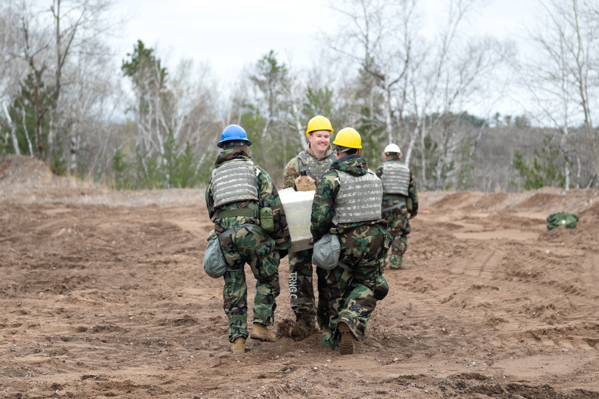 U.S. Air Force Airmen from the 205th Engineering Installation Squadron, Oklahoma Air National Guard, and the 210th Engineering Installation Squadron, Minnesota Air National Guard, move equipment in Camp Ripley, Minn., May 2, 2025.