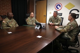 1st Lt. Juan Santiago (second from the left), financial officer, 1st Theater Sustainment Command, briefs his team in the G8 section, Fort Knox, Kentucky.
