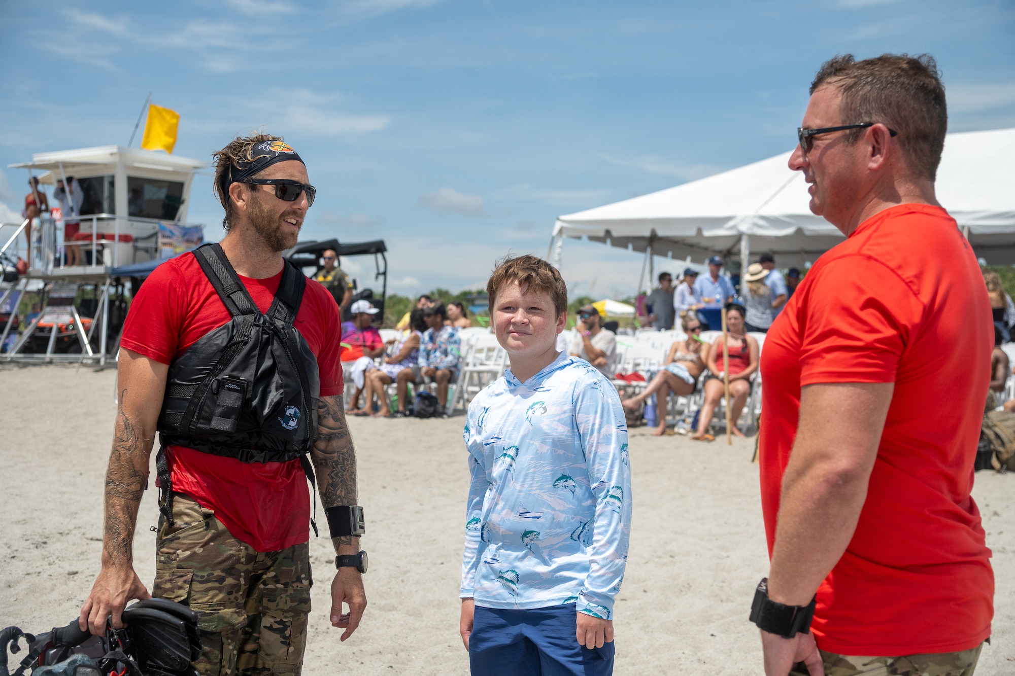 Jackson Posch stands between Tech. Sgt. Creighton Trott, left, and Lt. Col. Jim Sluder, right, during the Cocoa Beach Air Show, July 12, 2025. Both pararescuemen served alongside Jackson’s father, Master Sgt. William Posch, and continue to mentor Jackson as part of the 920th Rescue Wing family.
