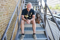 Todd Mitchell, an electronics technician at 582nd Missile Maintenance Squadron, with his Jim Morrison bust June 13, 2025, at Hill Air Force Base, Utah. (U.S. Air Force photo by Cynthia Griggs)