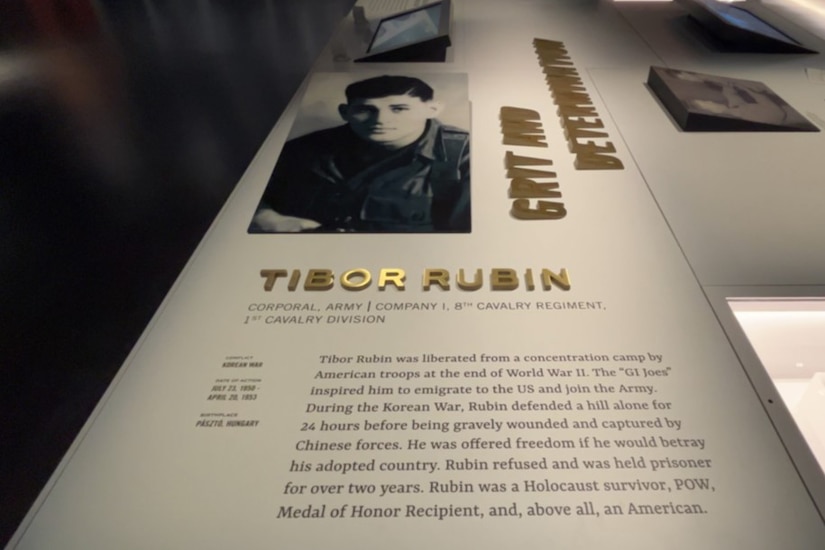 A photo and writing detailing the actions of a Medal of Honor recipient are posted in a display.
