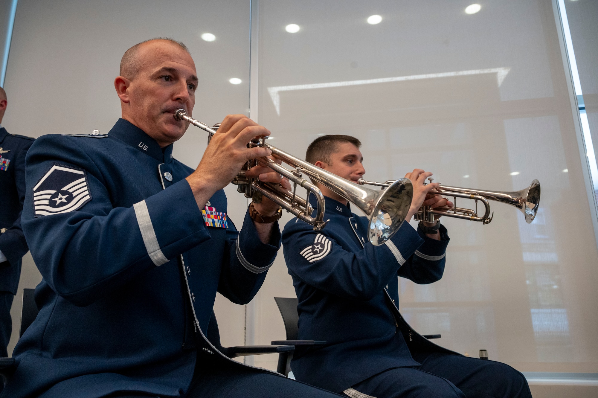 U.S. Air Force Master Sgt. Justin Stamps, left, and Tech. Sgt. Alex Szasz, both trumpet players with The U.S. Air Force Band’s Ceremonial Brass, perform during an enlistment ceremony at the Air & Space Forces Association headquarters in Arlington, Va., July 11, 2025. The Ceremonial Brass performed at the ceremony as one of more than 1,000 ceremonial performances each year. (U.S. Air Force photo by Hayden Hallman)