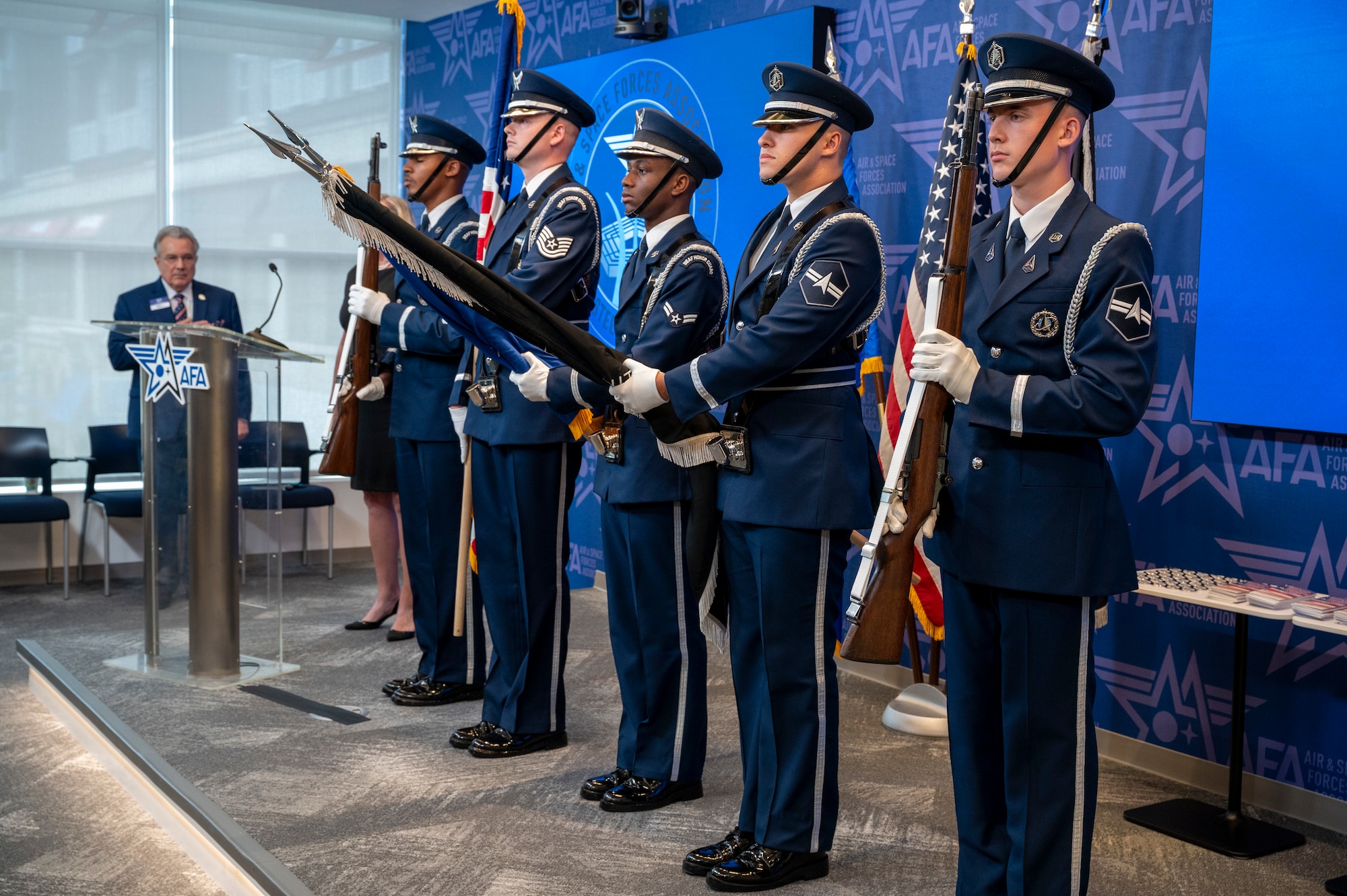 Members of the U.S. Air Force Honor Guard present the colors during the singing of “The Star-Spangled Banner” during an enlistment ceremony at the Air & Space Forces Association headquarters in Arlington, Va., July 11, 2025. The Honor Guard presented the colors to support their mission of delivering premier ceremonial honors, inspiring the nation and representing all Airmen and Guardians to the world. (U.S. Air Force photo by Hayden Hallman)