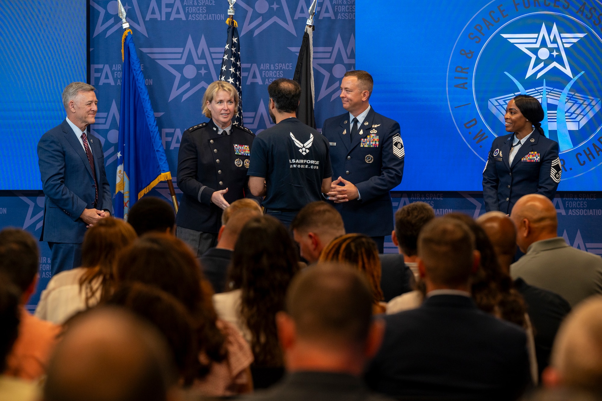 U.S. Space Force Lt. Gen. DeAnna M. Burt, Deputy Chief of Space Operations for Operations, Cyber, and Nuclear, shakes the hand of a delayed entry program recruit during an enlistment ceremony at the Air & Space Forces Association headquarters in Arlington, Va., July 11, 2025. Burt administered the oath of enlistment to the delayed entry program recruits prior to their ship date to basic military training. (U.S. Air Force photo by Hayden Hallman)
